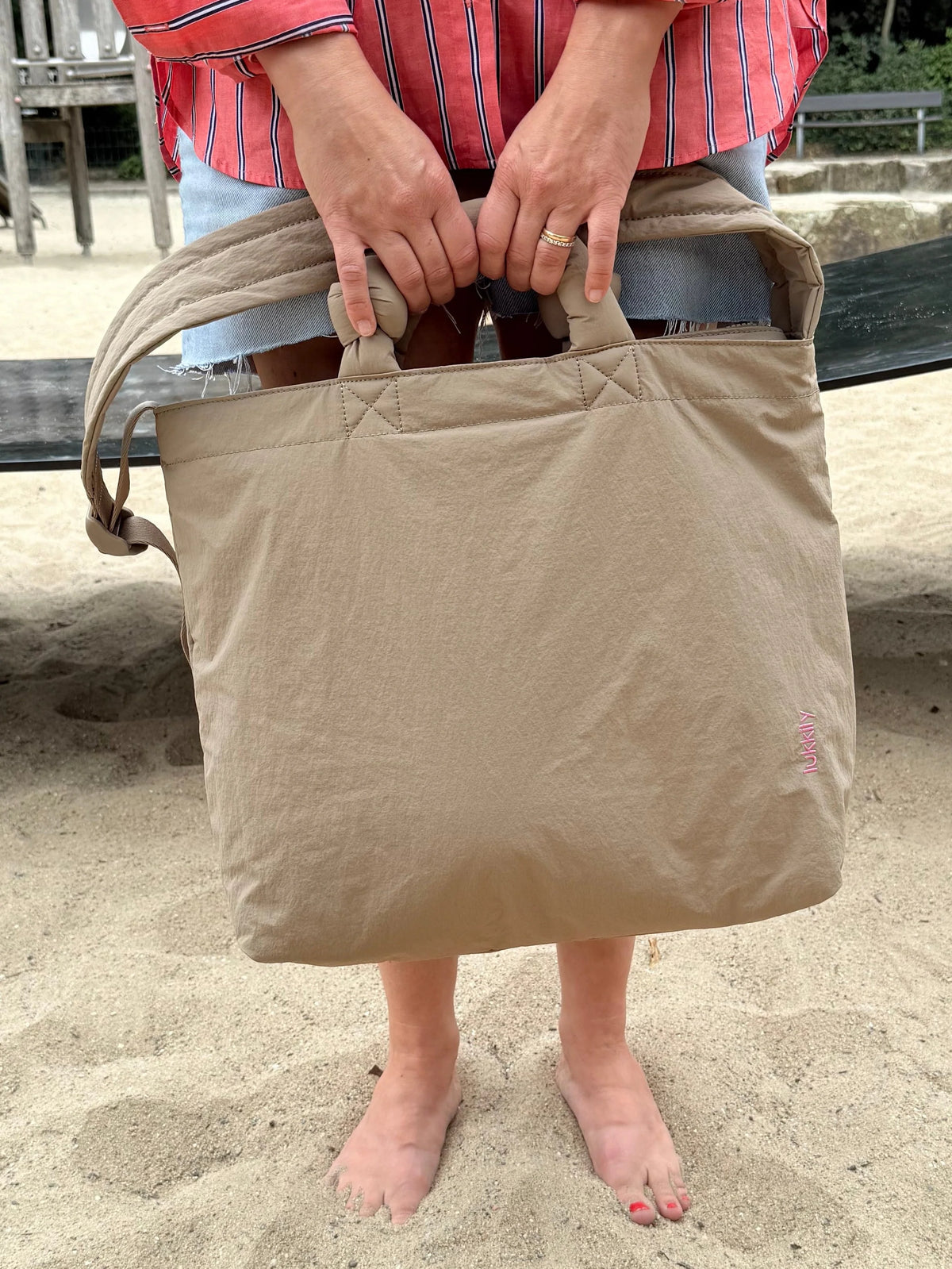 Beige Lukkily Tote Bag am kurzen Henkel getragen